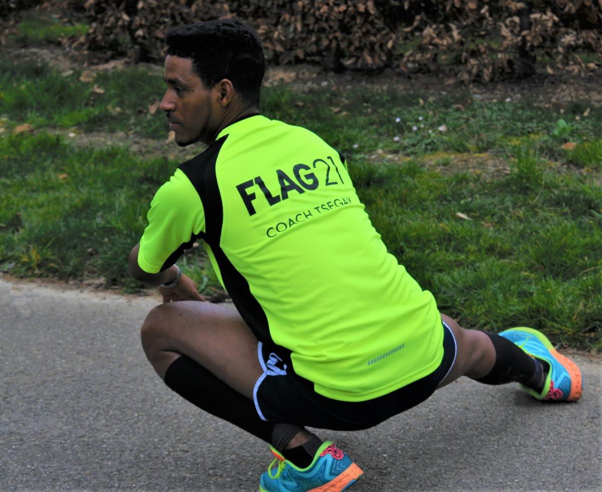 Tsegay, one of the FLAG21 coaches, stretches before training. ©FLAG21