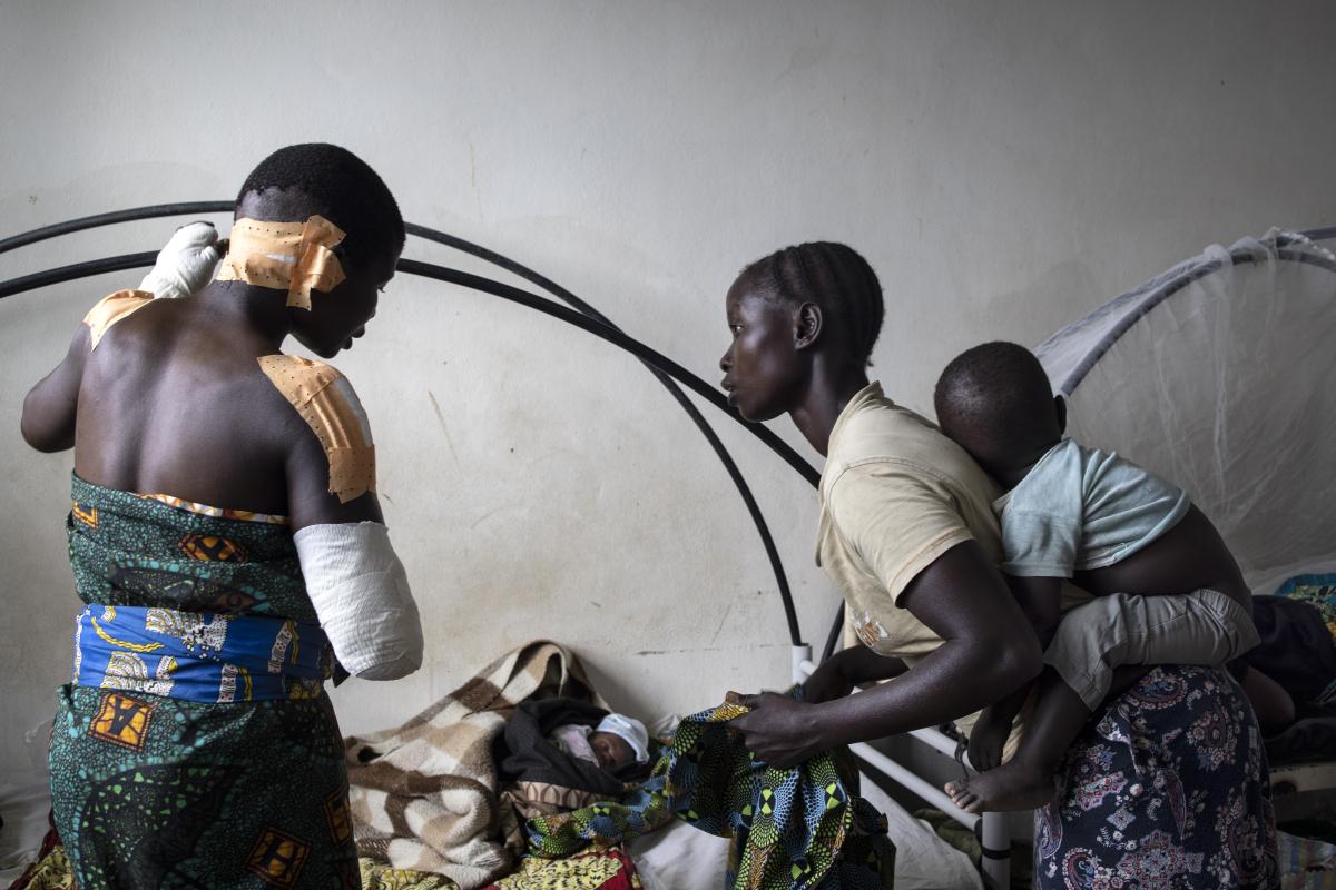 Madeleine erholt sich im Krankenhaus mit ihrem Baby nach dem Angriff auf ihr Dorf im März 2022. © UNHCR/Hélène Caux 